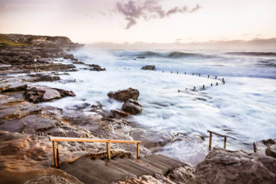 Iconic Sydney Ocean Pool. Under Siege, Mahon Pool, Maroubra covered in crashing waves.