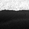 Waves flowing over Waianapanapa State Park Black Sand Beach