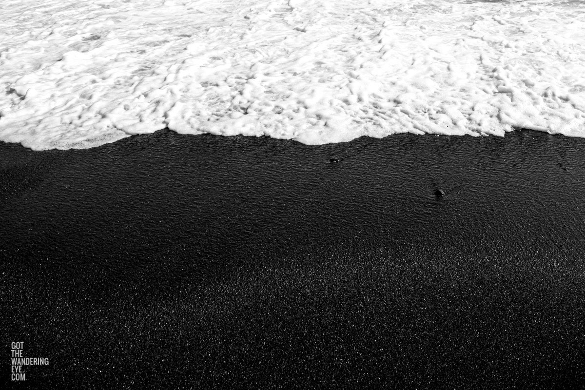 Waves flowing over Waianapanapa State Park Black Sand Beach