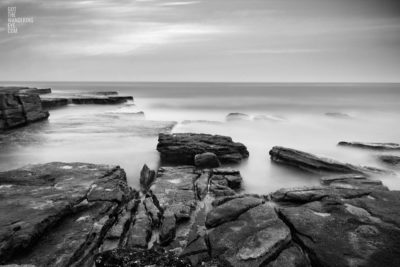 Long Exposure Sydney Photography. Silky waves flowing over rock face at Mahon Pool, Maroubra.