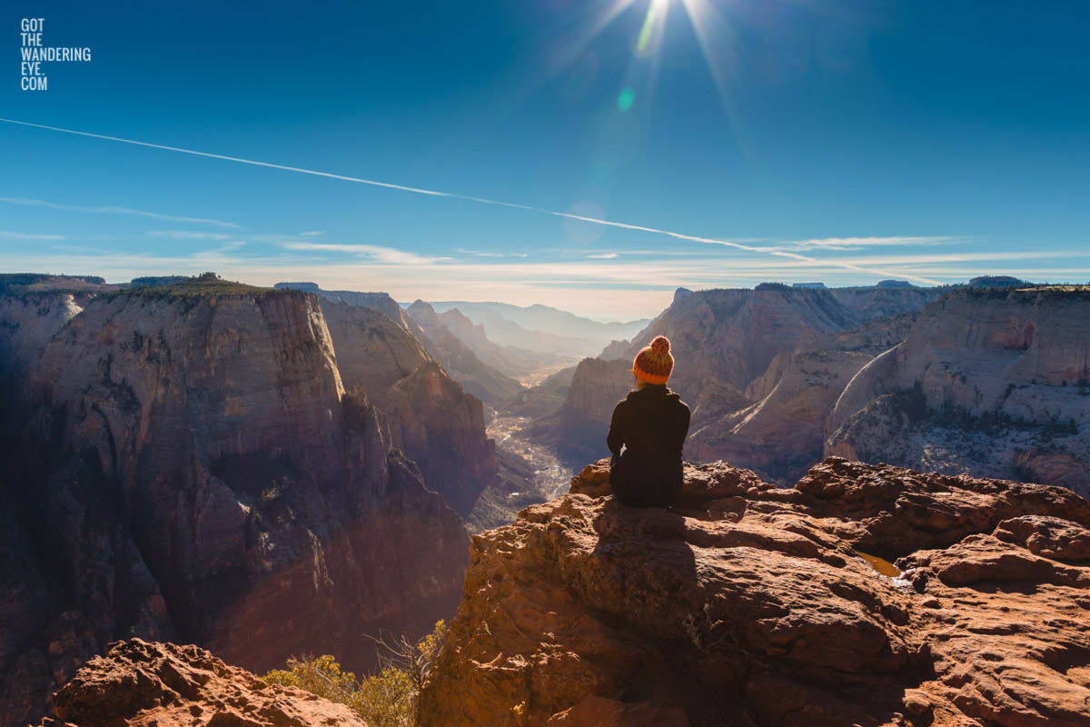 Woman sitting on top of Observation Point Zion Utah