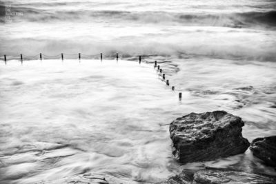 Black & White Long Exposure with big waves crashing over Mahon Pool, Maroubra