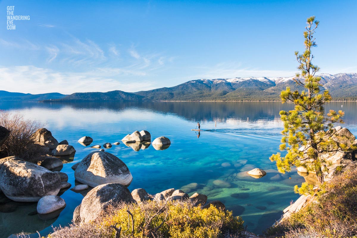 Paddleboarding Lake Tahoe. Nevada. Beautiful mountain, lake, boulders.