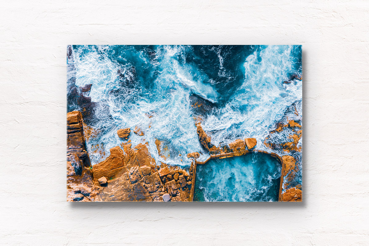 Aerial seascape above an empty icy cold Mahon Pool, Maroubra