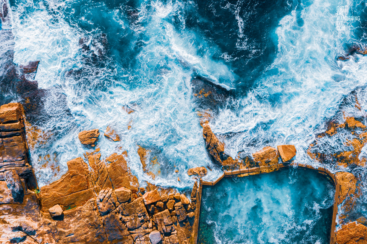 Aerial seascape above an empty icy cold Mahon Pool, Maroubra