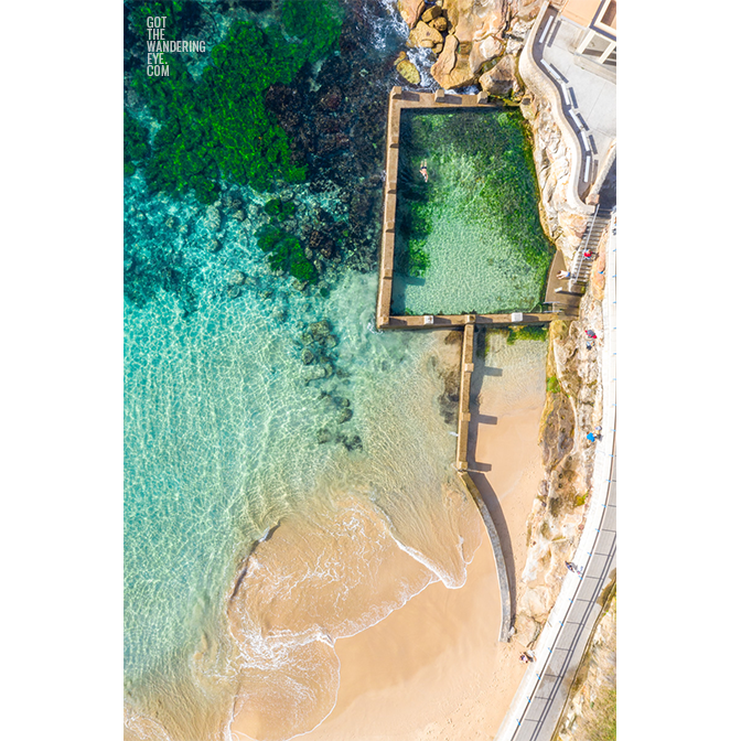 Aerial beach shot above the seaside oceanpool and turquoise waters of Ross Jones Rockpool, Coogee