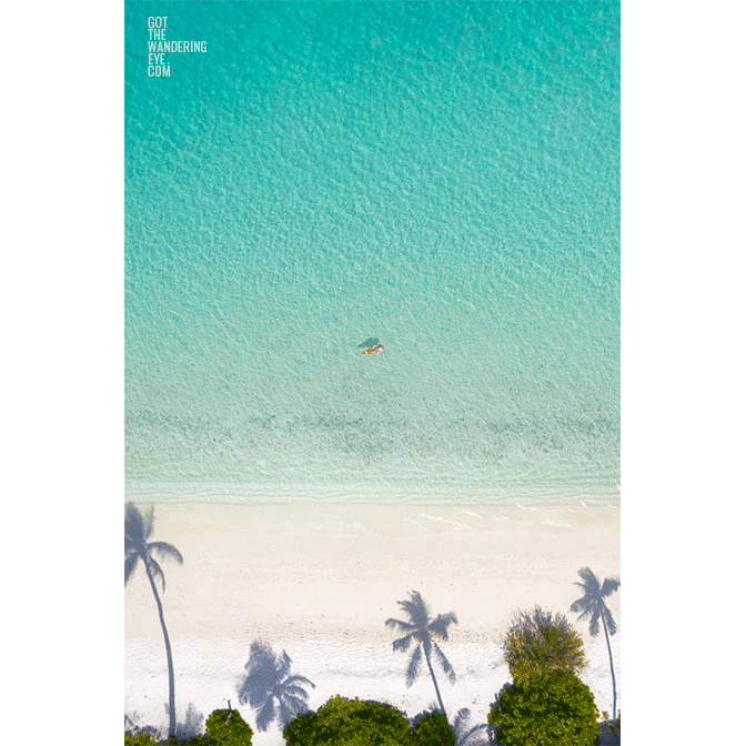 Aerial Woman on Beach, Maldives island paradise
