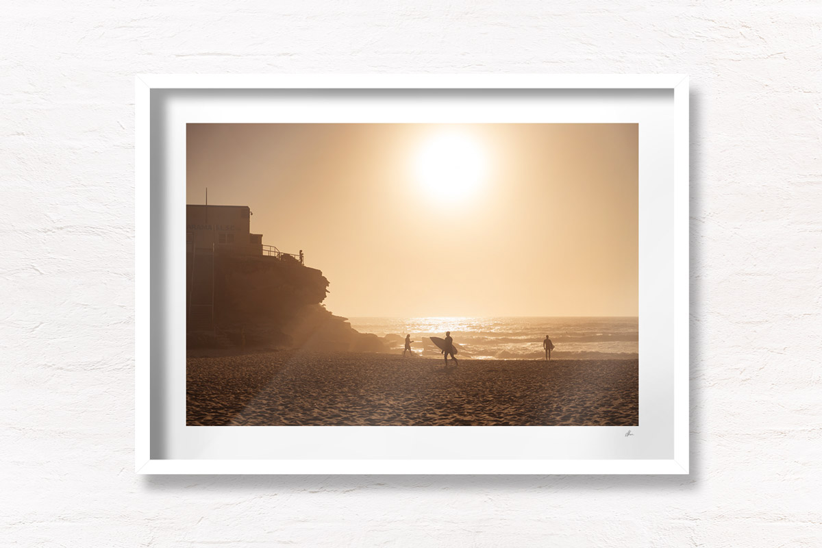 Surfers Tamarama Beach during a golden sunrise