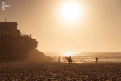 Surfers Tamarama Beach during a golden sunrise