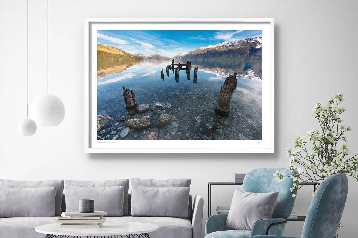 Interior styling inspiration. Fine art framed print of snow capped mountain landscape in Lake Wakitpu, New Zealand in modern home.