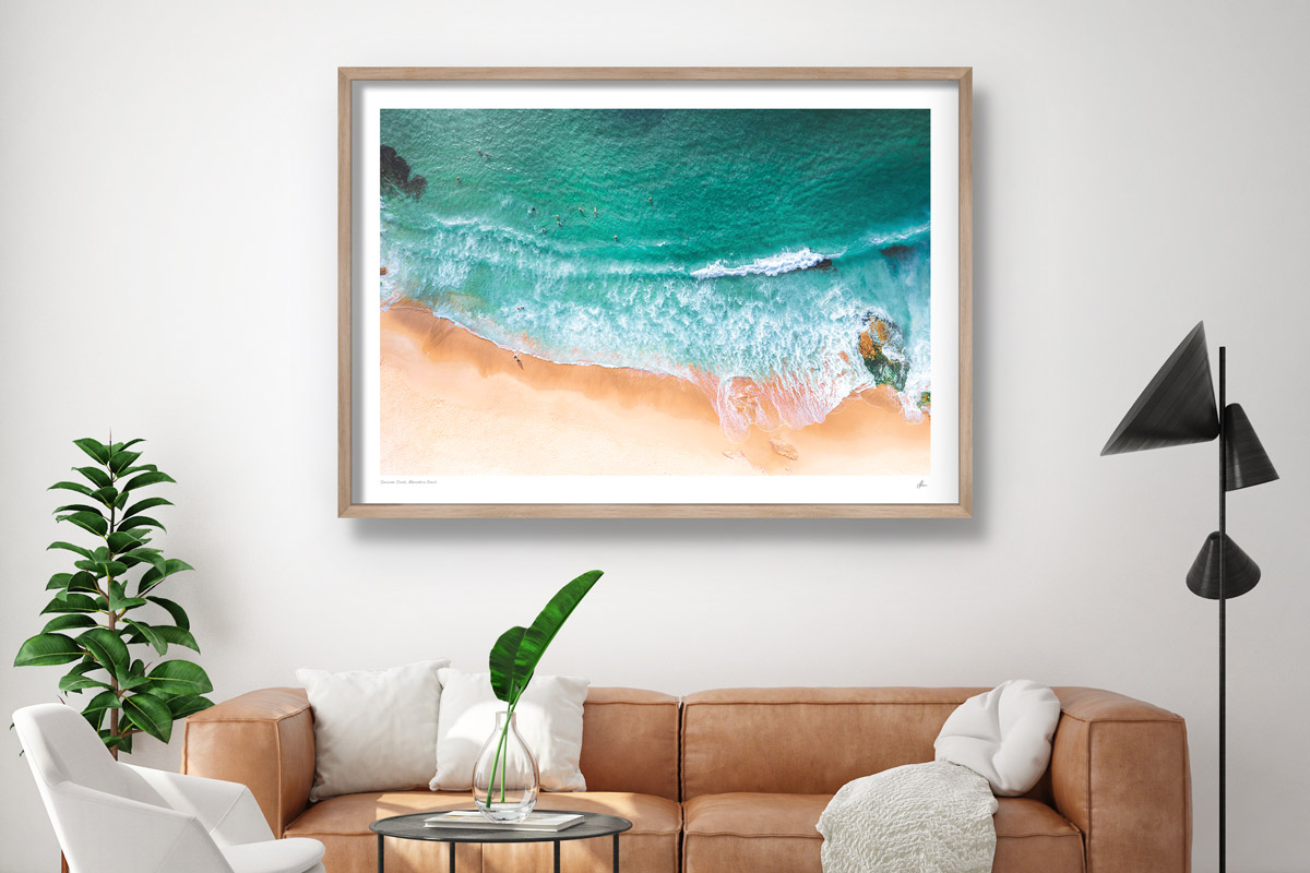 Interior design inspiration. Fine art print hanging in modern lounge room of an aerial photography above at Maroubra Beach