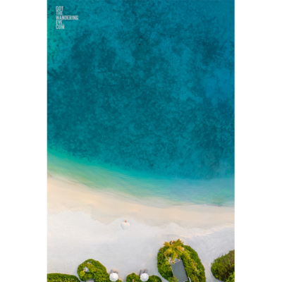 Fine Art Photography Print. Aerial oceanscape of woman standing on remote Maldivian Island.