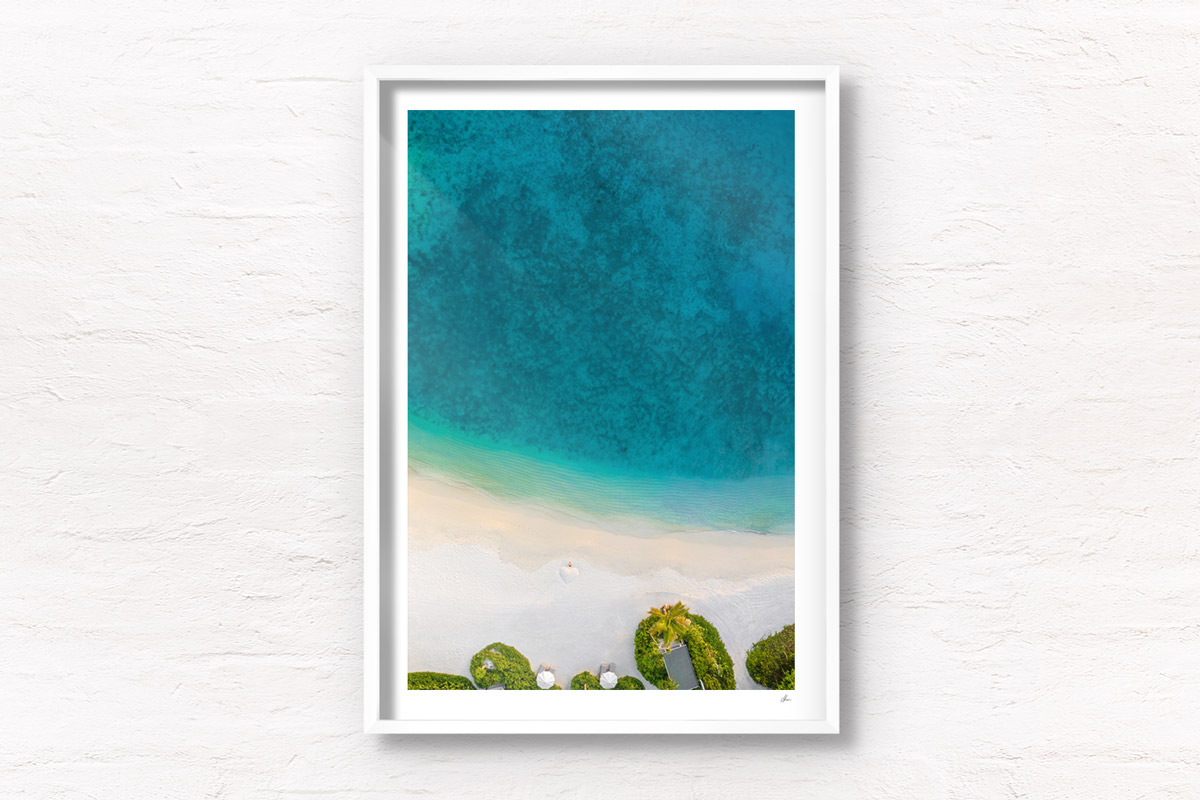 Fine Art Photography Print. Aerial oceanscape of woman standing on remote Maldivian Island.