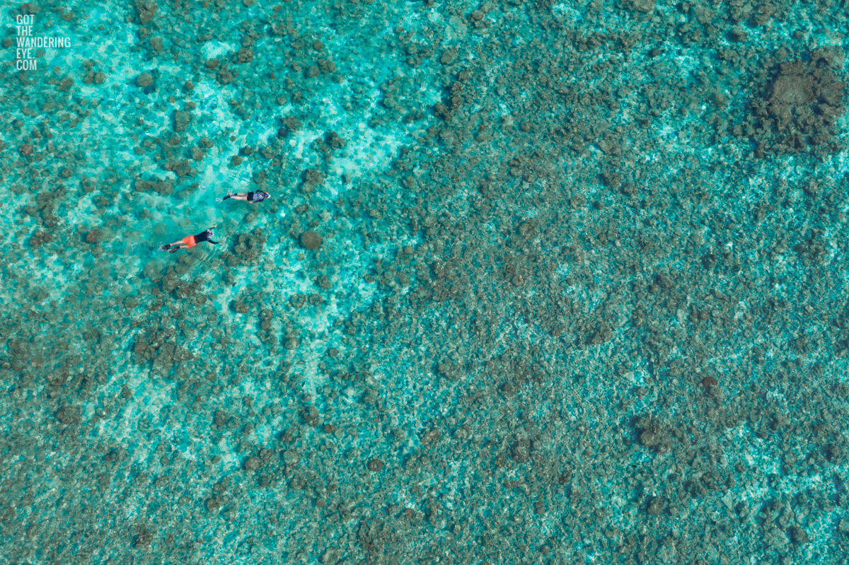 Fine Art Photography Print. Aerial, oceanscape of 2 people snorkelling in the clear waters of The Maldives