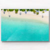 Aerial oceanscape of palm tree shadows on beautiful Maldivian Beach