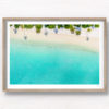 Aerial oceanscape of palm tree shadows on beautiful Maldivian Beach
