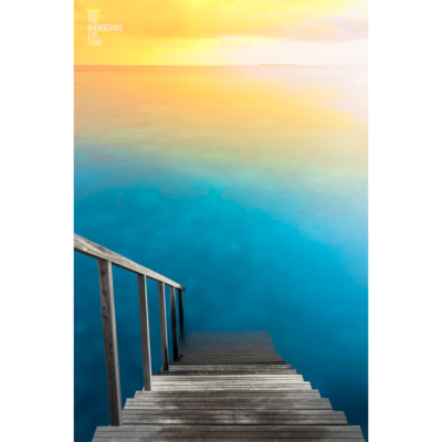 Incredible long exposure photograph of a sunrise over the indian ocean, Maldives. Taken from the steps of overwater bungalow. Water Villa Steps