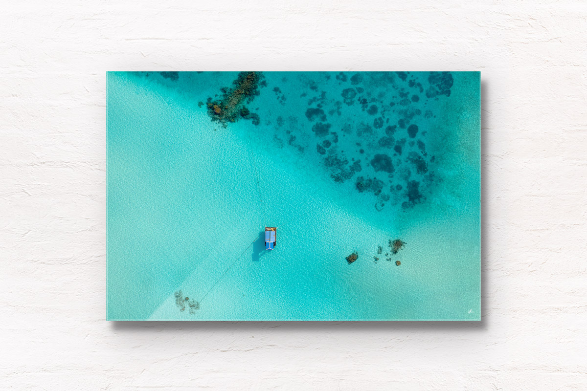 Aerial oceanscape image of boat anchored in the island paradise of the Maldives.