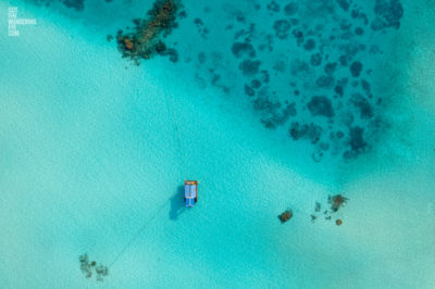 Aerial oceanscape image of boat anchored in the island paradise of the Maldives.