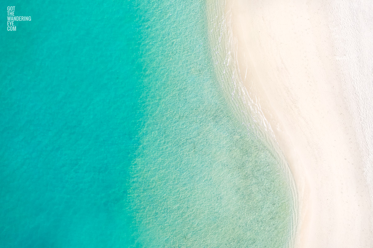 Aerial oceanscape close up of the crystal clear waters and sandy white beach of the Maldives. White Sand Beach