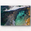 Aerial photograph of a man swimming in The Bogey Hole, Bronte Beach