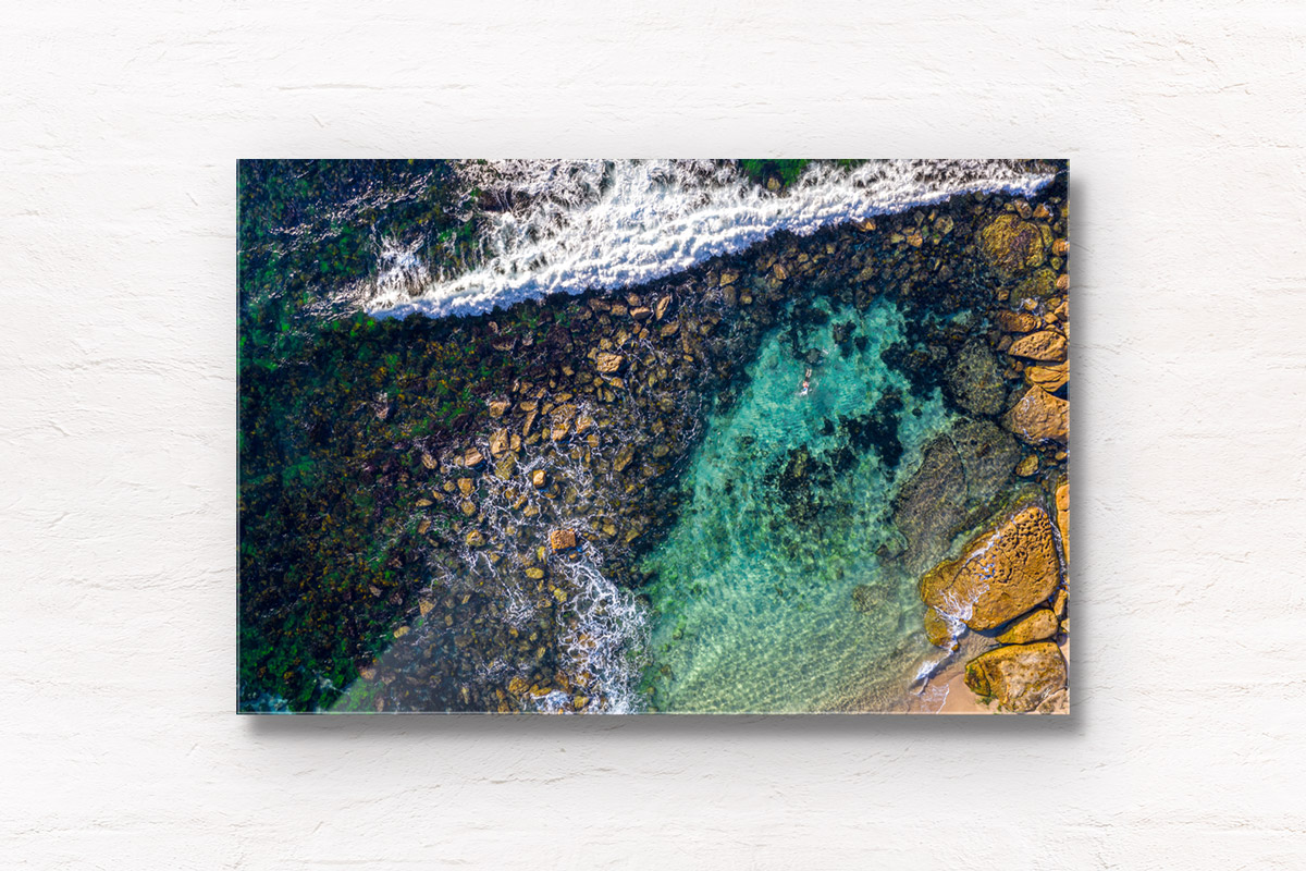 Aerial photograph of a man swimming in The Bogey Hole, Bronte Beach
