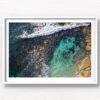 Aerial photograph of a man swimming in The Bogey Hole, Bronte Beach