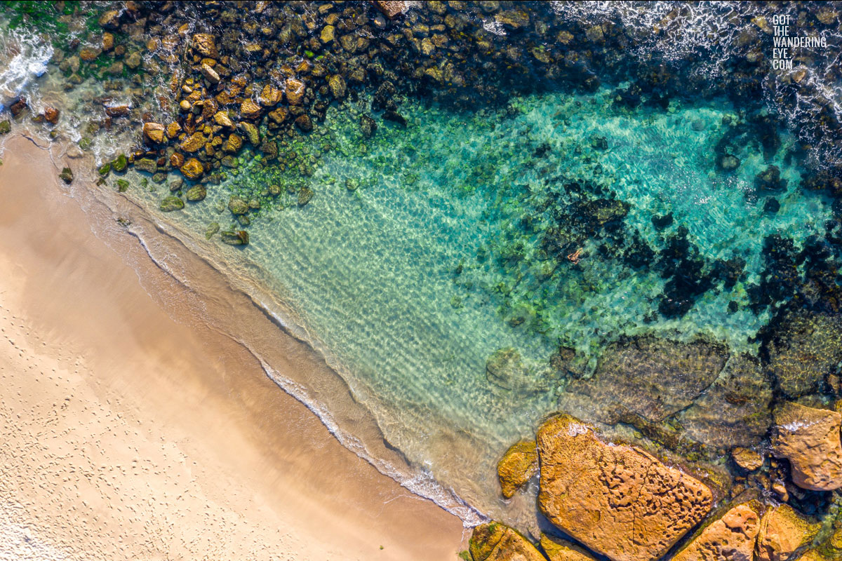 Aerial photograph of a woman swimming in The Bogey Hole, Bronte Beach