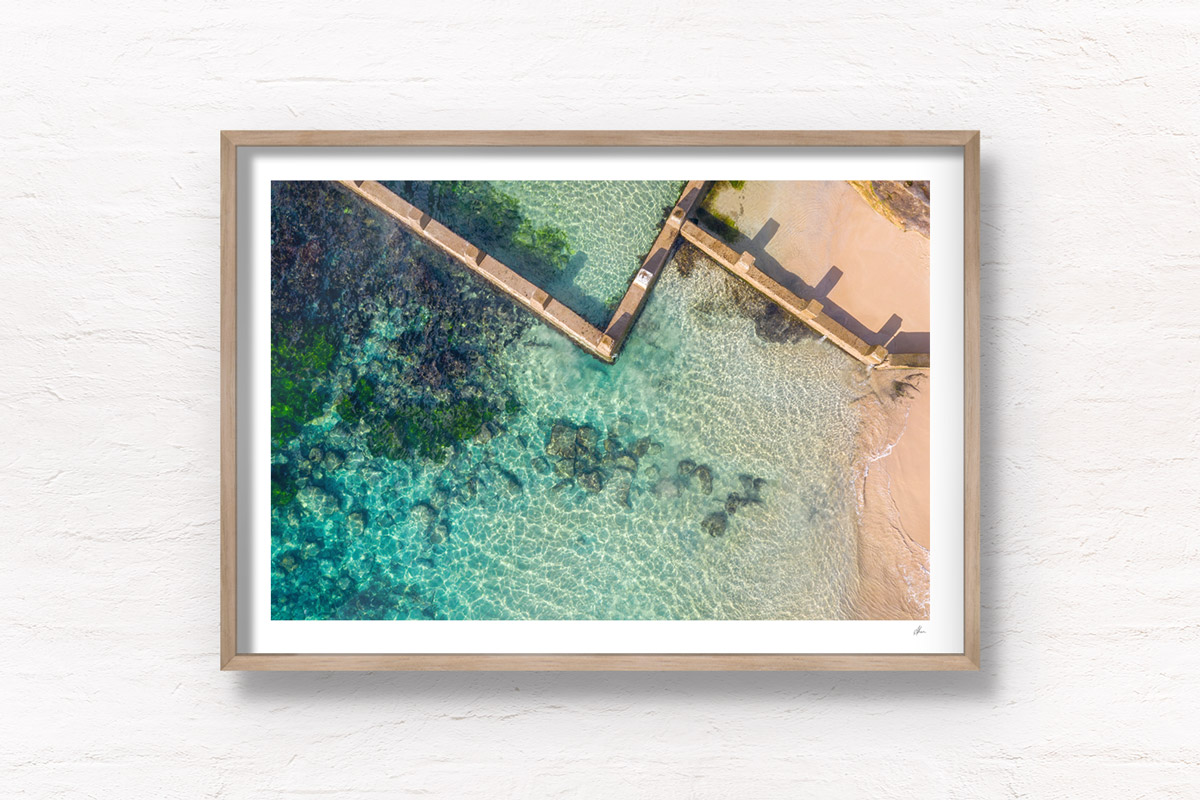 Aerial beach shot above the seaside oceanpool and turquoise waters of Ross Jones Rockpool, Coogee