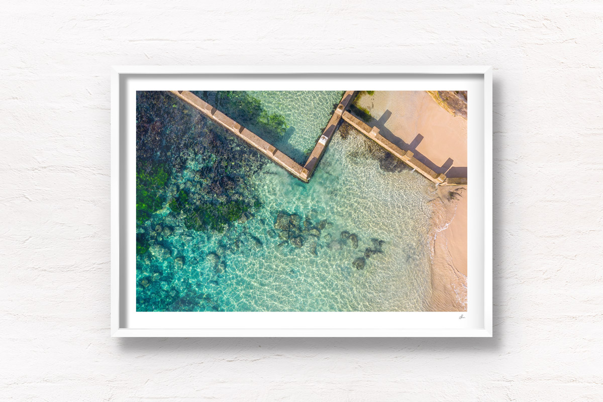 Aerial beach shot above the seaside oceanpool and turquoise waters of Ross Jones Rockpool, Coogee