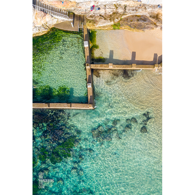 Aerial beach shot above the seaside oceanpool and turquoise waters of Ross Jones Rockpool, Coogee. Sydneys Best Rockpool