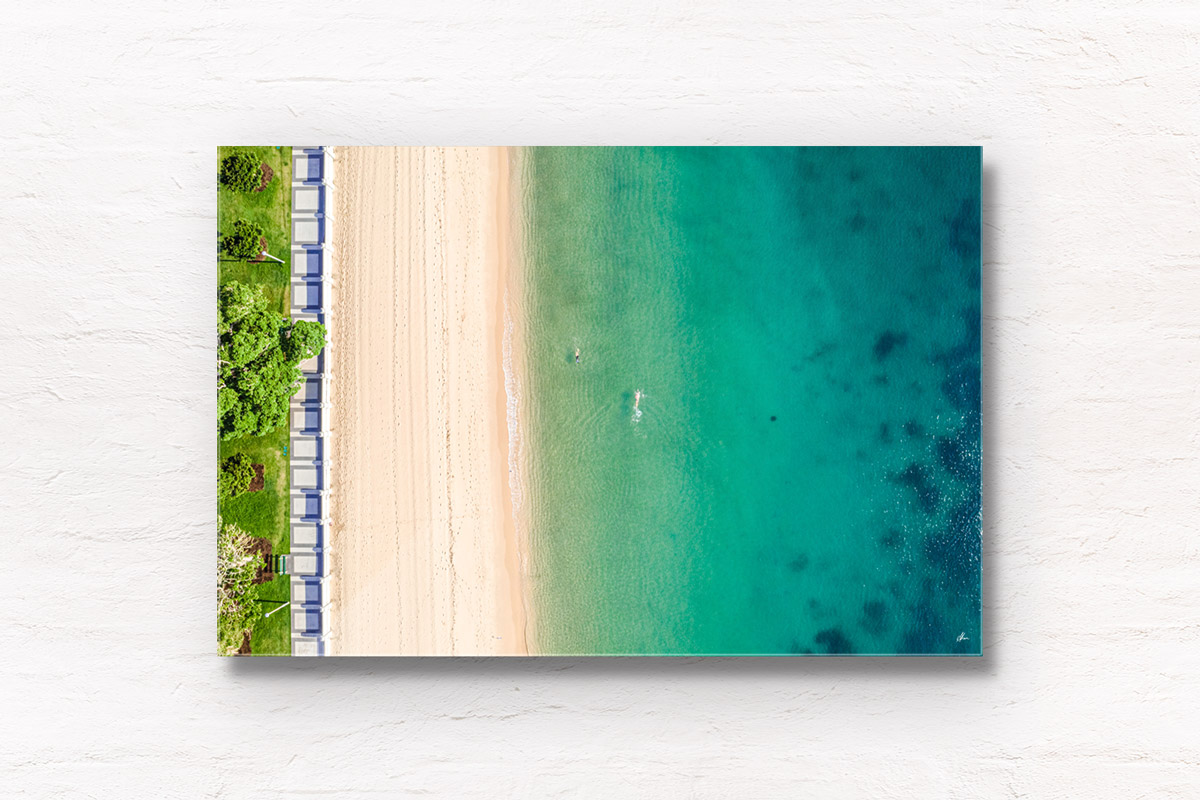 Aerial oceanscape of swimmers enjoying a morning swim on the foreshore of the historic Balmoral Beach promenade