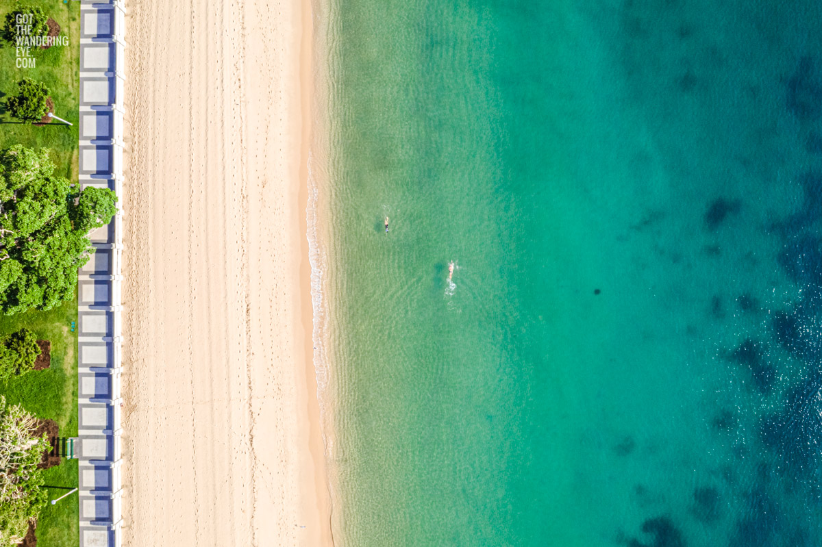 Aerial oceanscape of swimmers enjoying a morning swim on the foreshore of the historic Balmoral Beach promenade