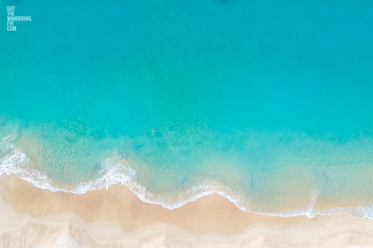 Aerial oceanscape of a lone swimmer enjoying the beautiful calm turquoise waters of Coogee Beach