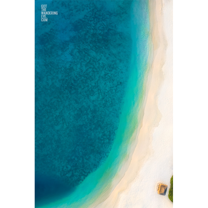 Aerial oceanscape above a beach hut in the Maldives