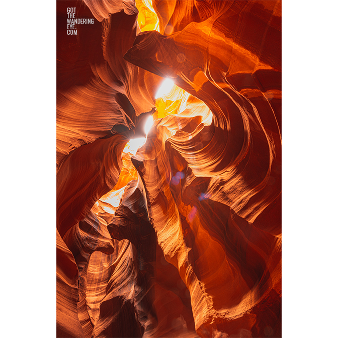 Looking up to the sky through the swirling sandstone textures of the slot canyon at upper Antelope Canyon, Arizona.