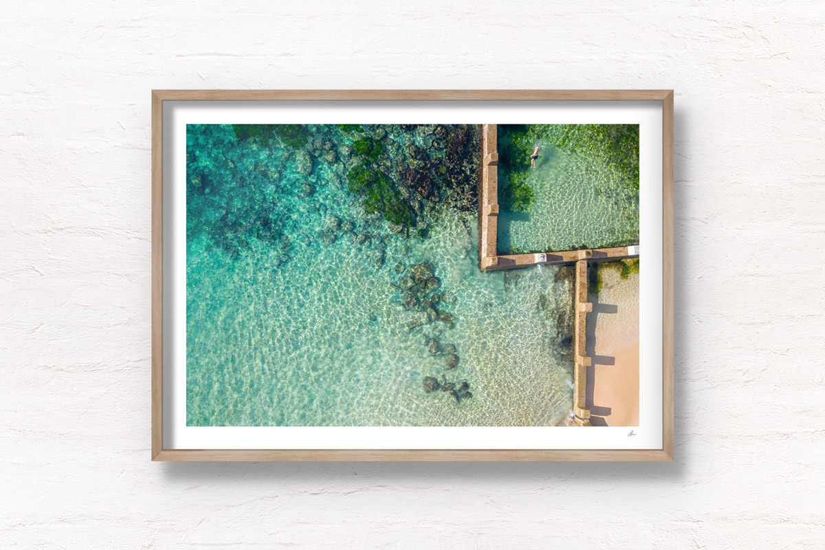 Aerial beach shot above the seaside oceanpool and turquoise waters of Ross Jones Rockpool, Coogee