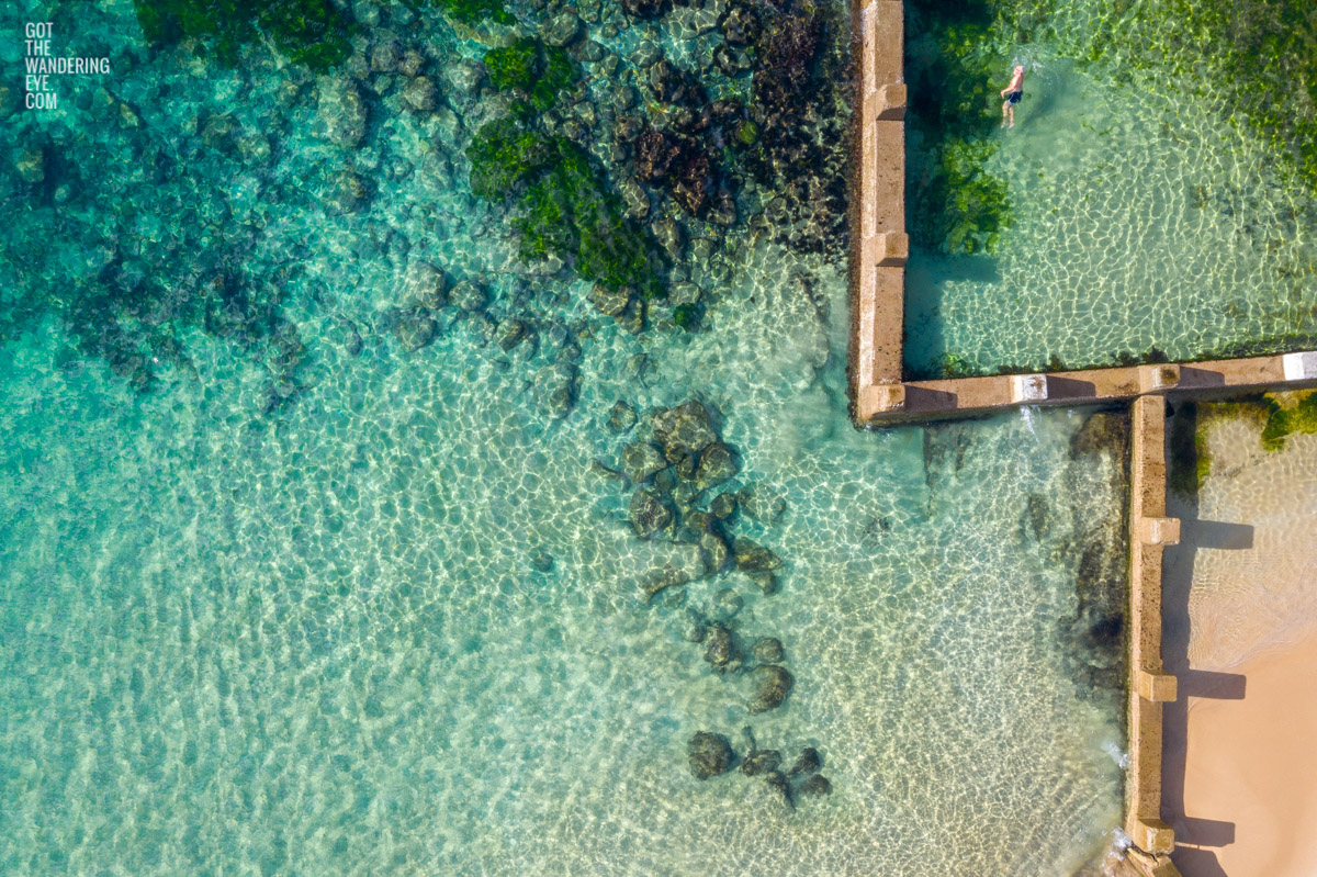 Aerial beach shot above the seaside oceanpool and turquoise waters of Ross Jones Rockpool, Coogee