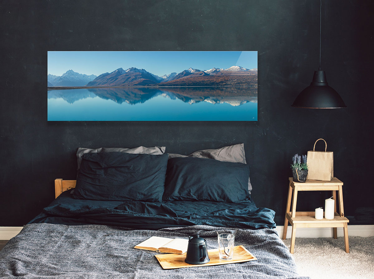 Interior styling inspiration. Acrylic Facemount panorama print of stunning Lake Tekapo New Zealand hanging in bedroom.