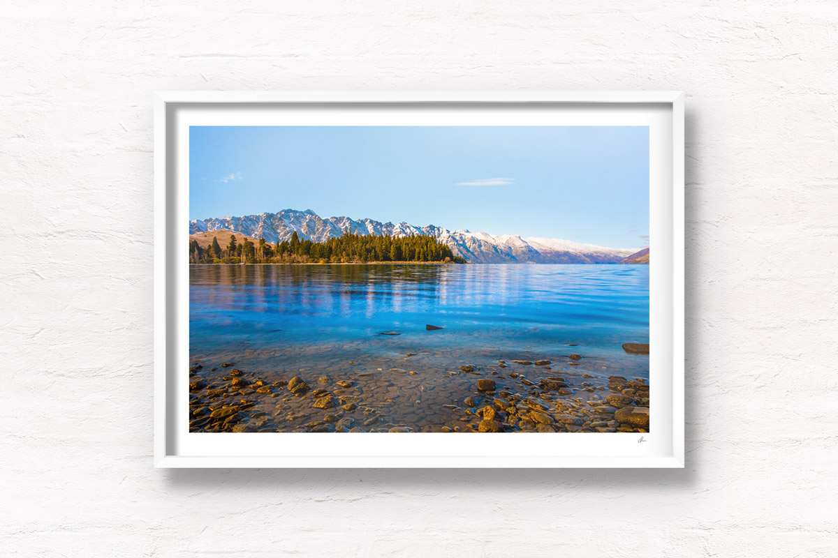 Lakeside at Lake Wakitipu, looking out towards snowcapped mountains, Queenstown, New Zealand.