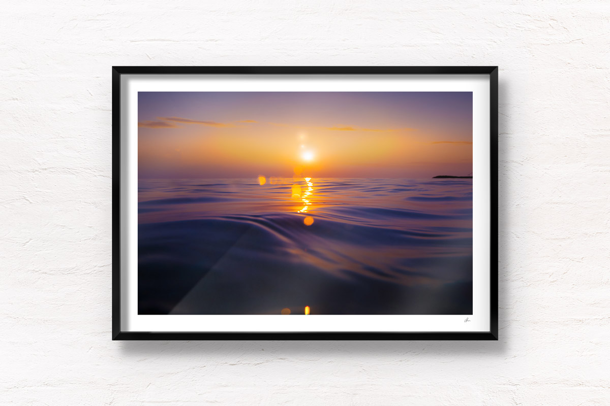 Stunning bokeh sunrise rising over the ocean waters of the Maldives