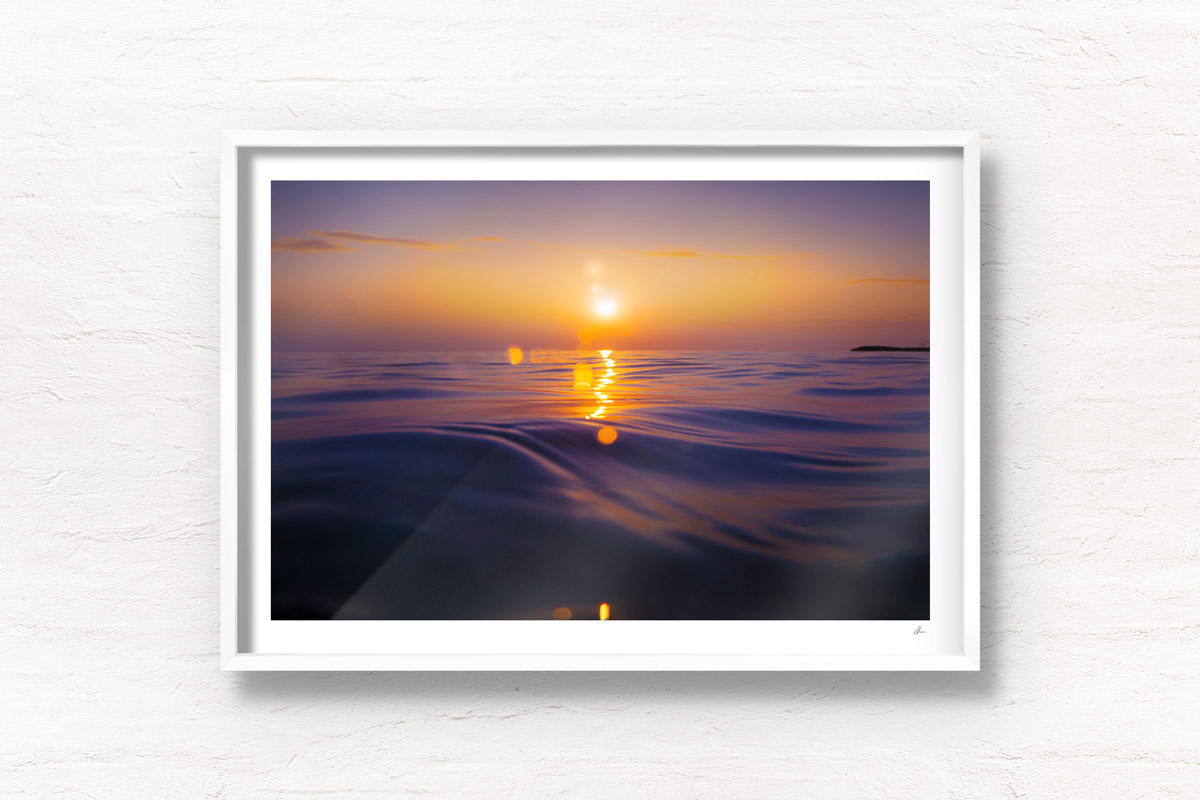 Stunning bokeh sunrise rising over the ocean waters of the Maldives