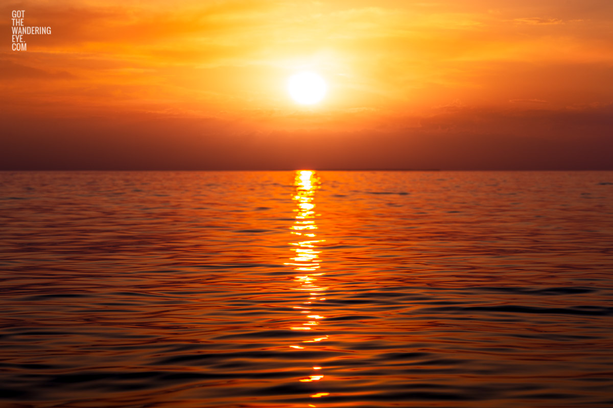 Fiery morning sunrise rising over the waters of the Maldives. Beach Sunrise Photography