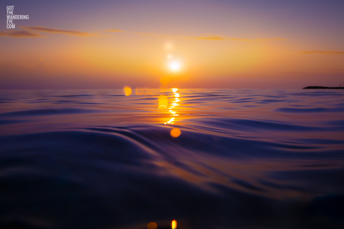 Stunning bokeh sunrise rising over the ocean waters of the Maldives