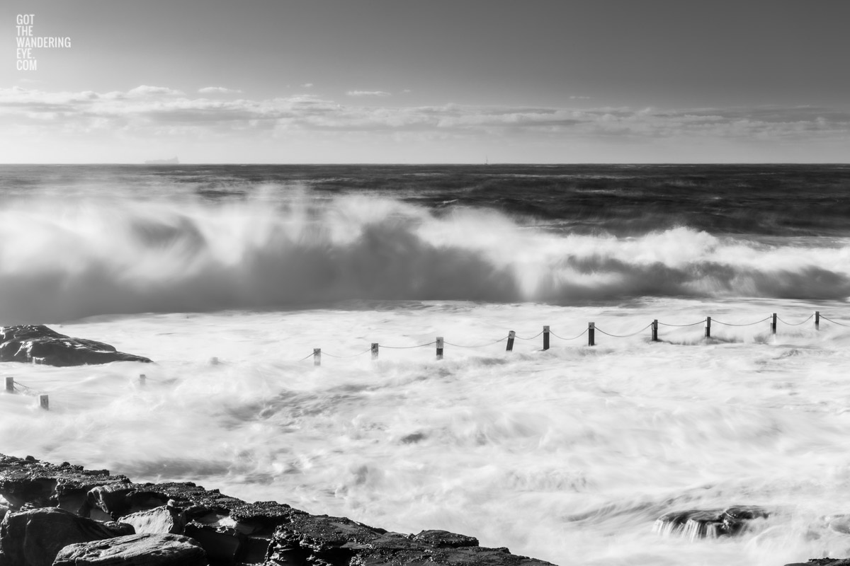 Black & White image of huge waves crashing over Mahon Pool, Maroubra