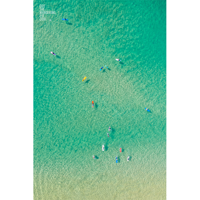 Aerial oceanscape above crystal clear waters on Bondi beach with colourful surfboards. Surfers Aerial View
