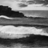 Black and white photo of huge waves crashing over Bondi Beach