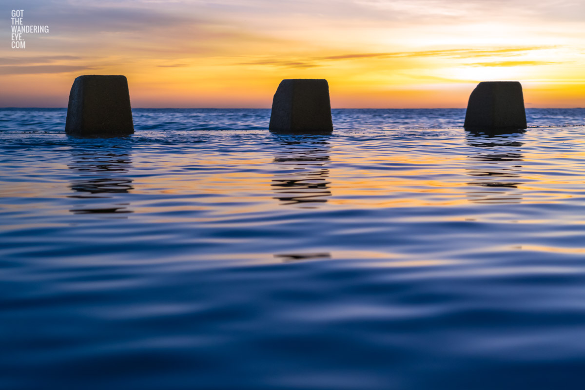 Close up of calm water and ocean ripples of The Ross Jones Memorial Pool at Coogee during a beautiful sunrise