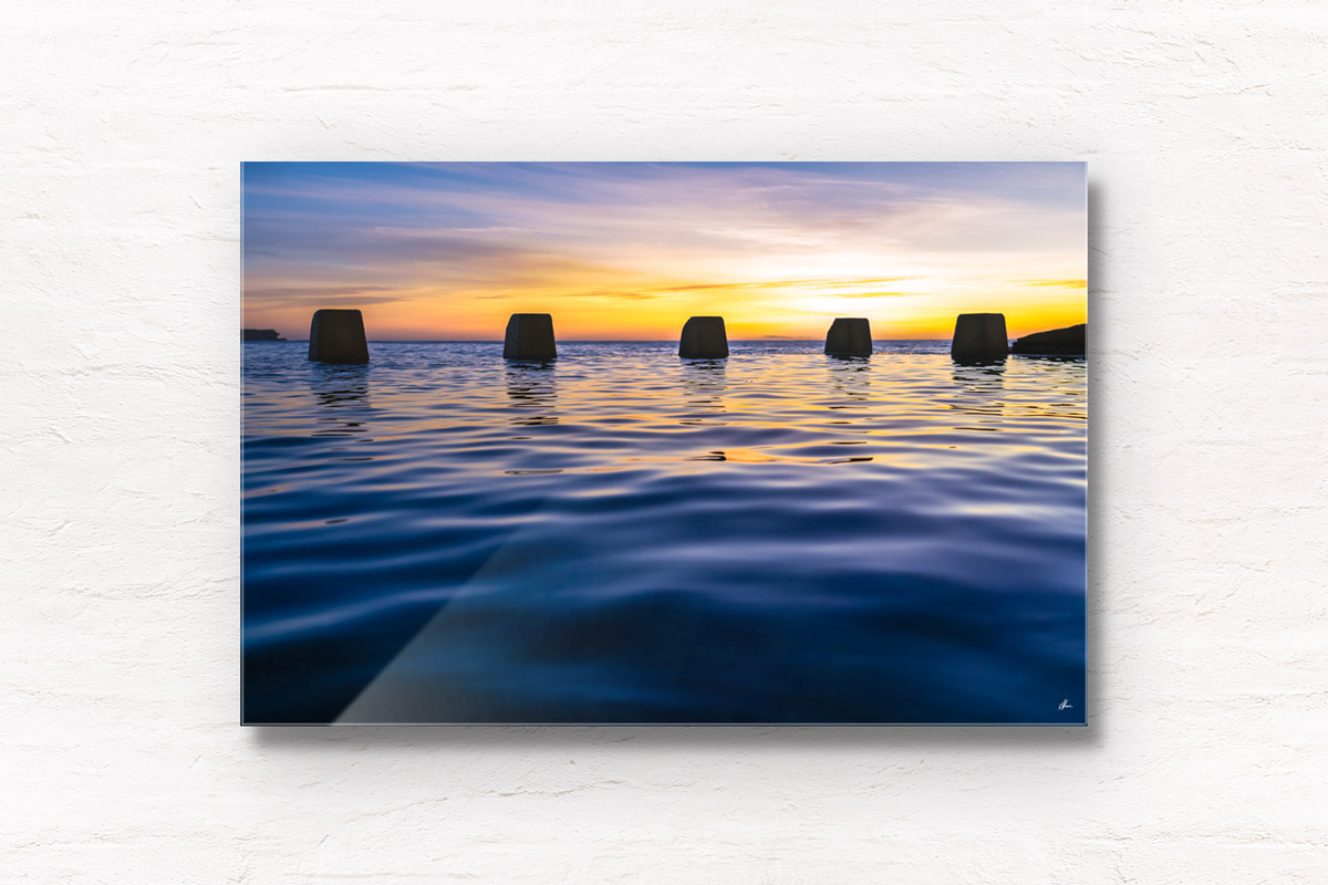 Close up of calm water and ocean ripples of The Ross Jones Memorial Pool at Coogee during a beautiful sunrise