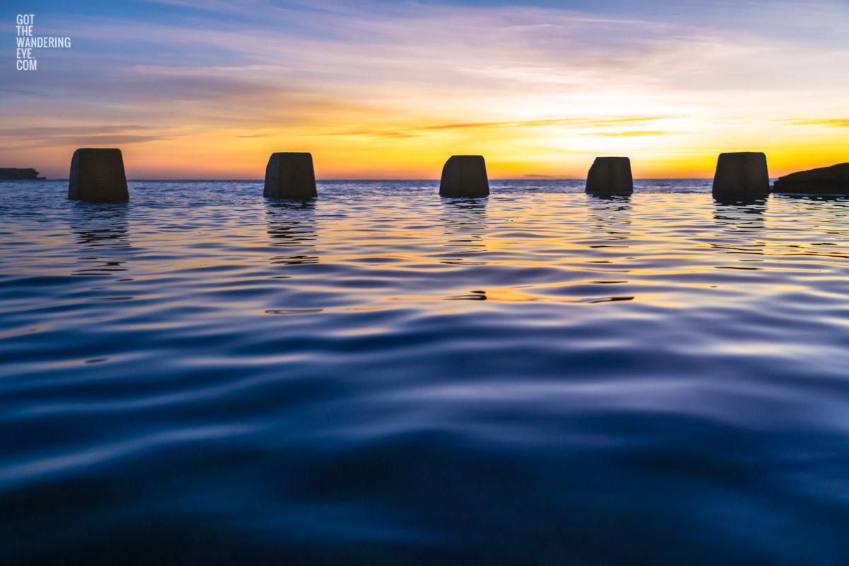 Close up of calm water and ocean ripples of The Ross Jones Memorial Pool at Coogee during a beautiful sunrise